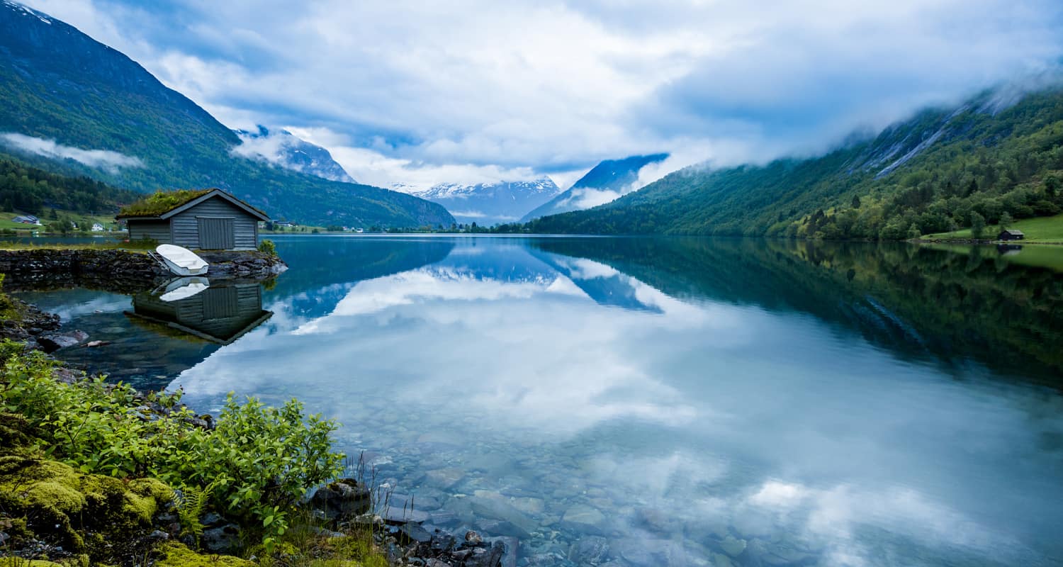 Landscape photo of a blue lake between mountains.